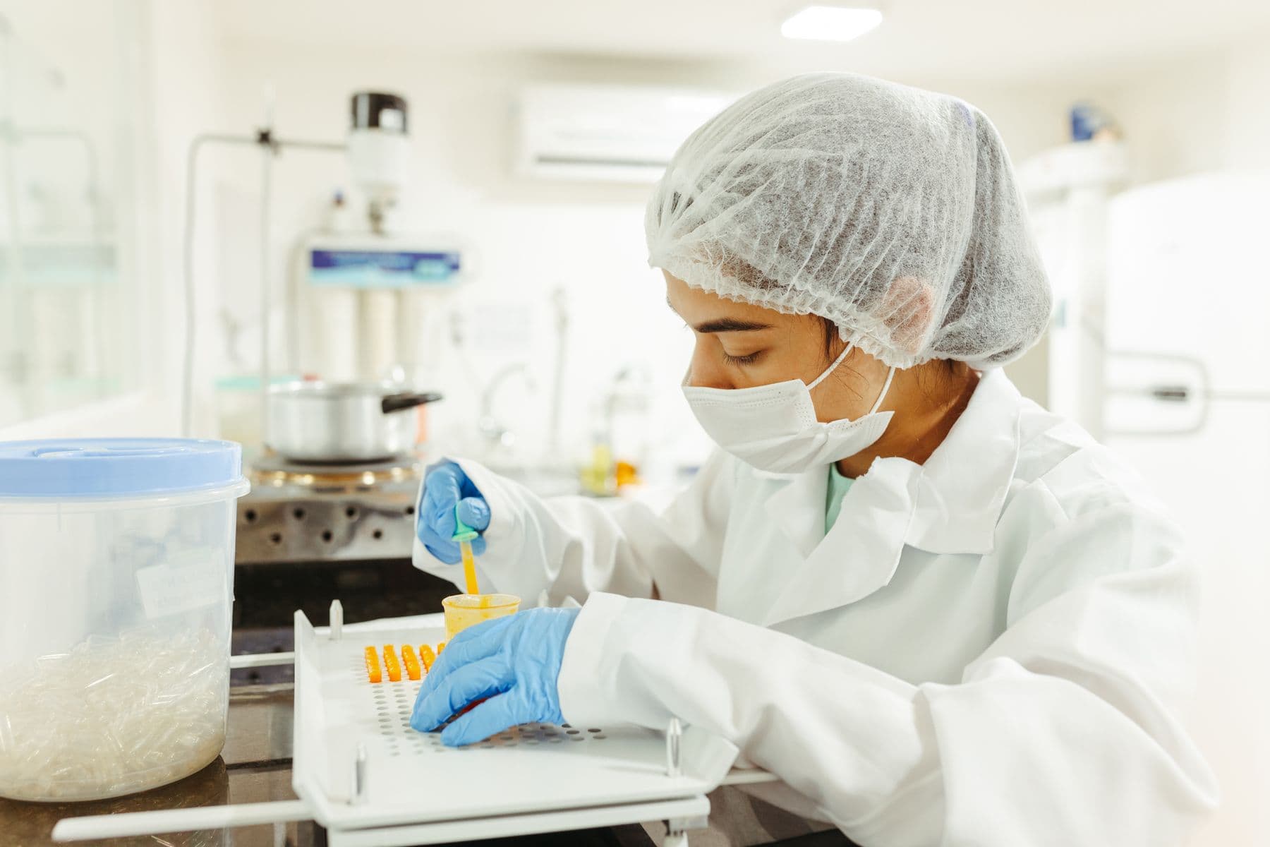 Food technologist testing a powder sample in a quality control laboratory